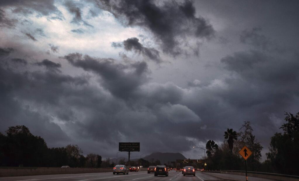 Storm clouds form over the Hollywood Freeway in Los Angeles, Friday, Feb. 17, 2017. Wet weather has returned to California with the first in a new series of rainstorms moving across the northern half of the state while the south awaits a tempest that forecasters say could be the strongest in years if not decades. (AP Photo/Richard Vogel)