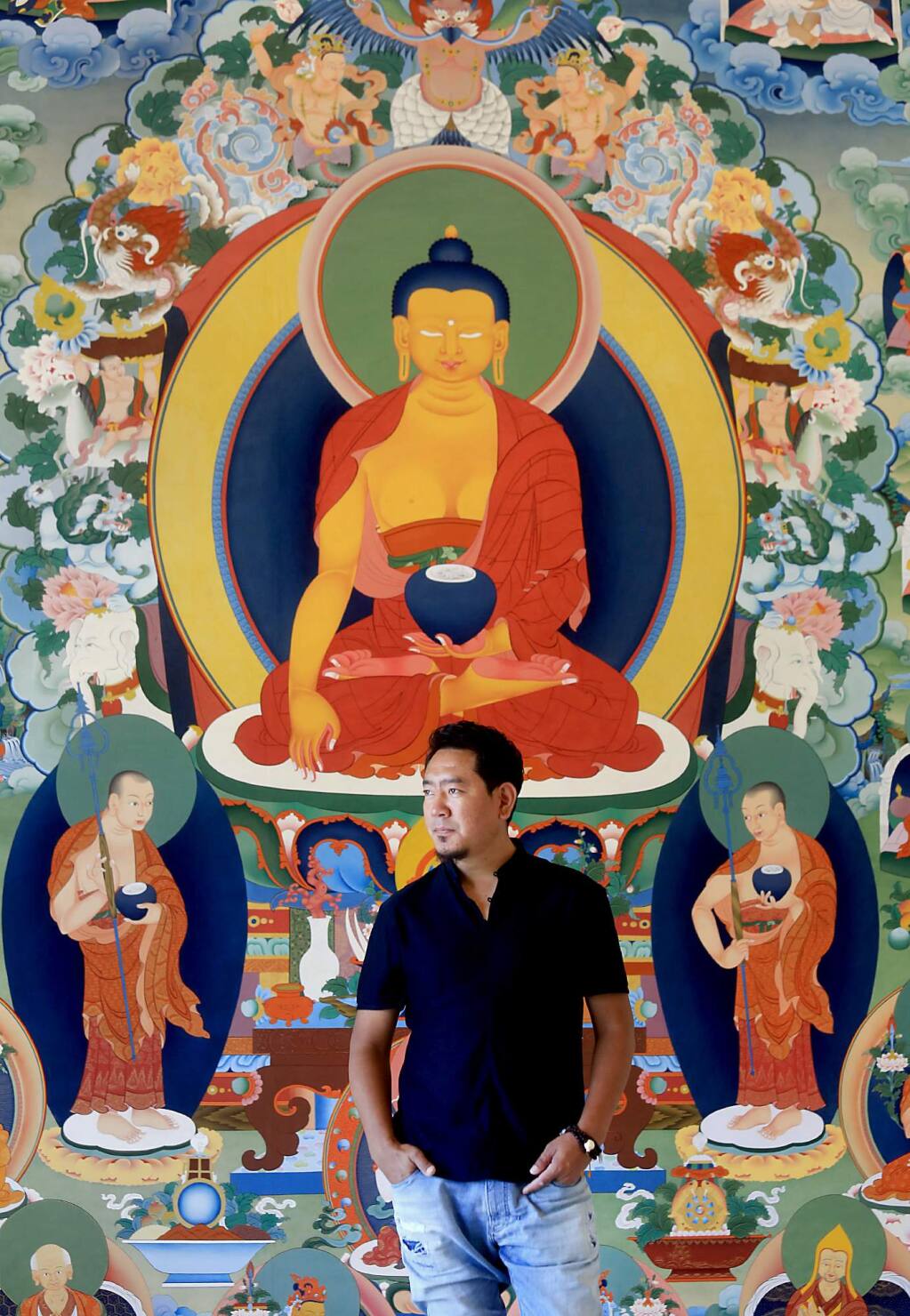 Tibetan master artist Tashi Dhargyal with a traditional Buddhist mural, a thangka. During the past four years Dhargyal has been working on the mural in his studio at the Barlow in Sebastopol. (Kent Porter / Press Democrat) 2017