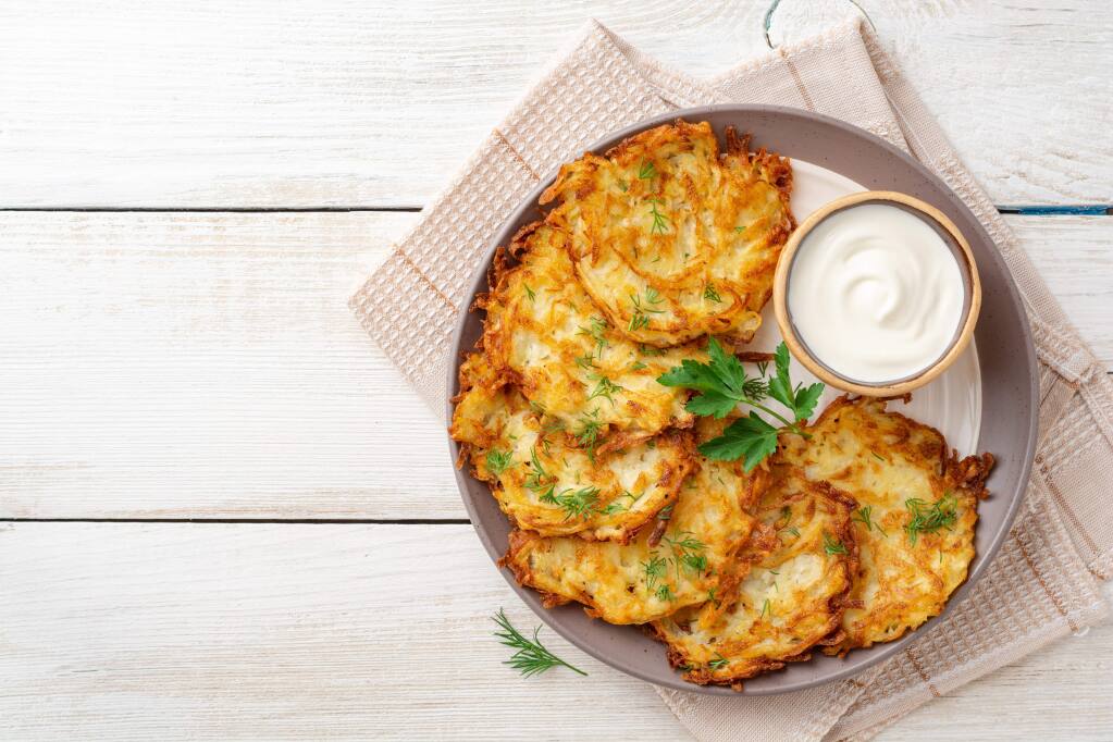 Latkes are often serve with sour cream and applesauce. For a more elegant latkes, serve with creme fraiche or sour cream, snipped chives and the best caviar you can afford.