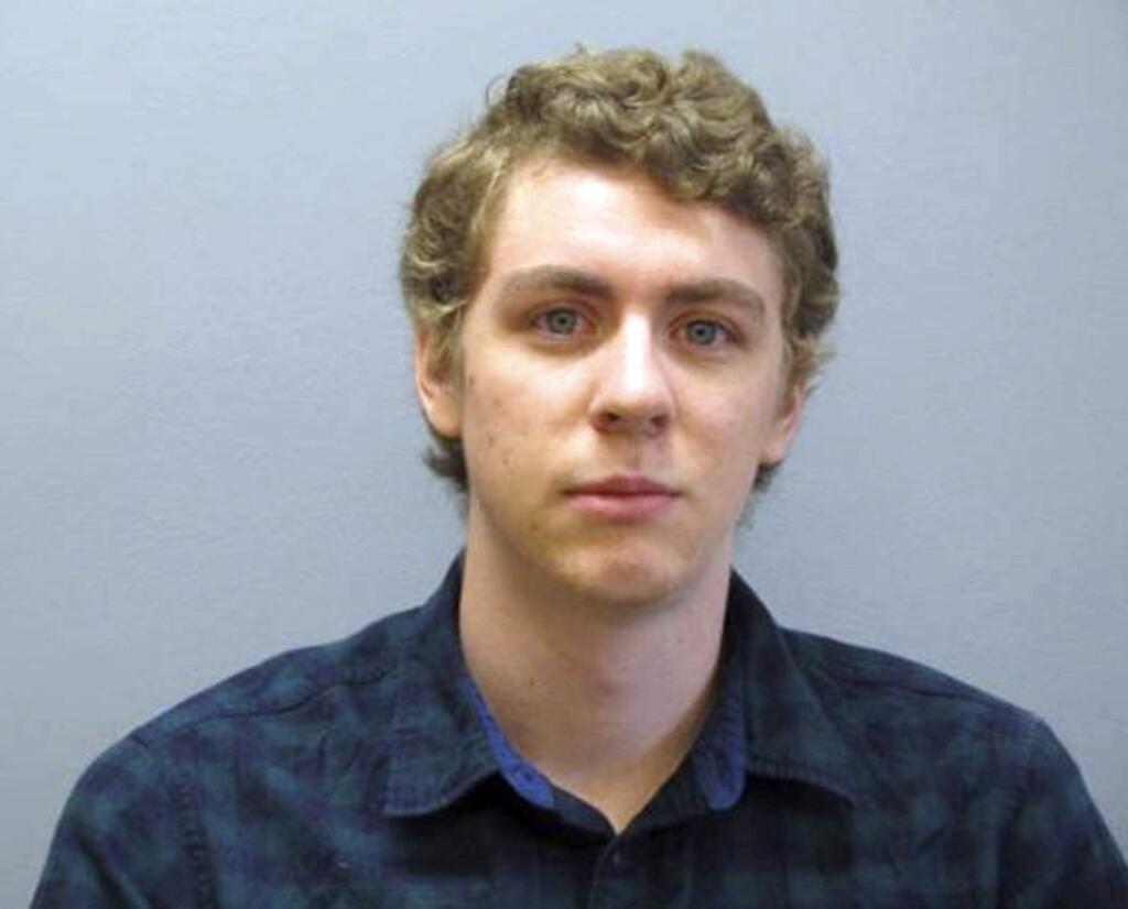 FILE - This Sept. 6, 2016 file photo provided by the Greene County Sheriff's Office shows former Stanford University swimmer Brock Turner at the sheriff's office in Xenia, Ohio, as he registered as a sex offender following his conviction on sexual assault charges in California. Lawyers for Turner filed an appeal of his conviction Friday, Dec. 1, 2017, saying the initial trial was 'a detailed and lengthy set of lies.' They hope a new trial will also help overturn his mandatory lifetime requirement to register as a sex offender. (Greene County Sheriff's Office via AP, File)