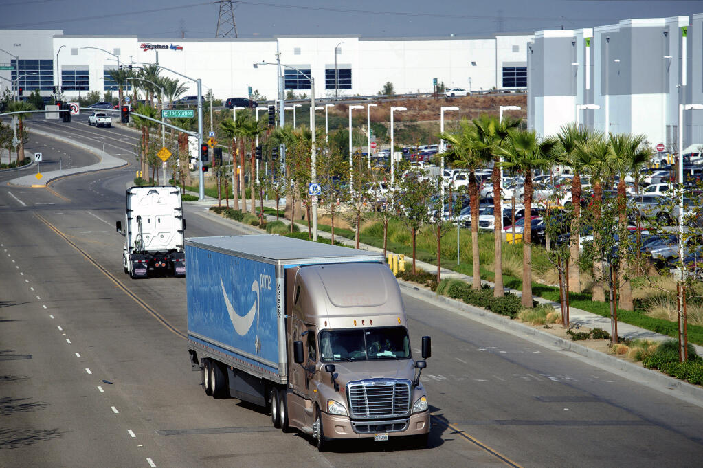A semi-truck turns into an Amazon Fulfillment center in Eastvale, California, on Nov. 12, 2020. (Watchara Phomicinda / The Orange County Register)