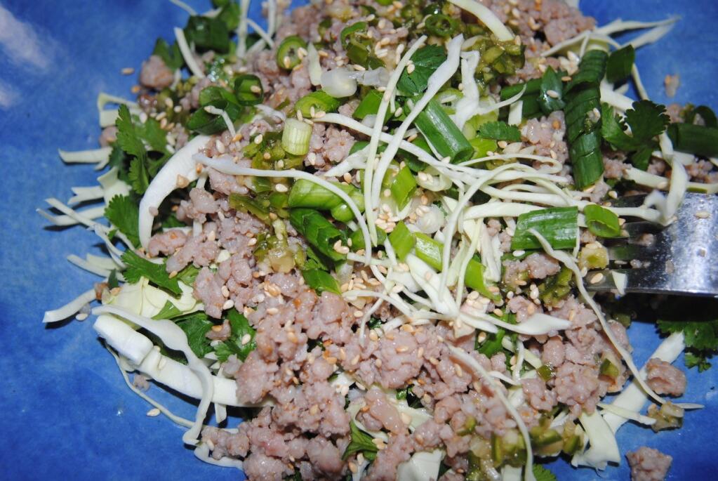 Thai Larb is finished with green onions, cilantro and cabbage. (Michele Anna Jordan)