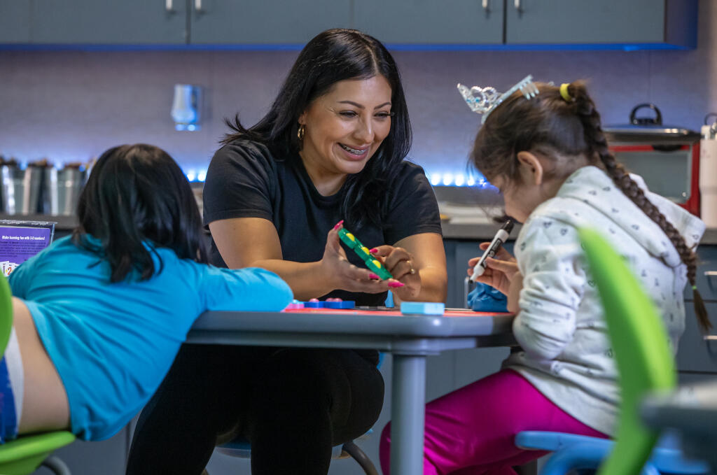 Albert Biella Elementary School special education teacher Nora Parajon laughs while working on numbers with students in her classroom at the Santa Rosa school, Friday, Sept. 8, 2023. (Chad Surmick / The Press Democrat)