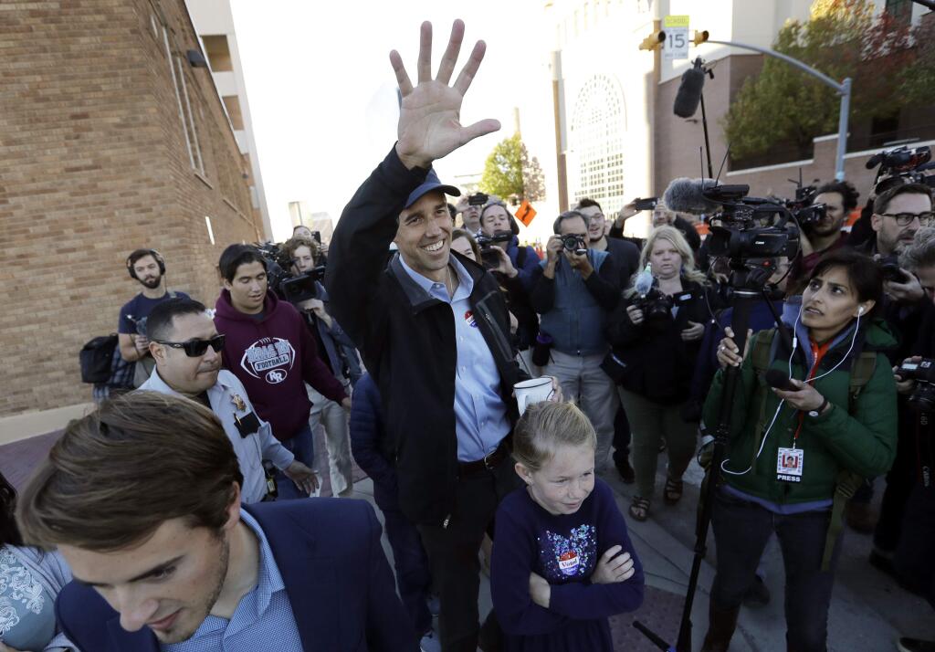 Rep. Beto O'Rourke, the 2018 Democratic Candidate for the Senate in Texas, waves to supporters as he leaves a polling place with his family after voting, Tuesday, Nov. 6, 2018, in El Paso. (AP Photo/Eric Gay)
