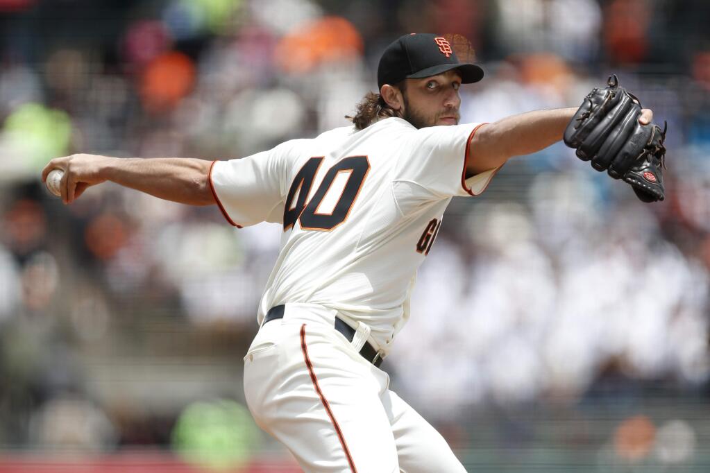 San Francisco Giants pitcher Madison Bumgarner winds up during the first inning of a game against the Los Angeles Dodgers, Thursday, May 21, 2015, in San Francisco. (AP Photo/Beck Diefenbach)
