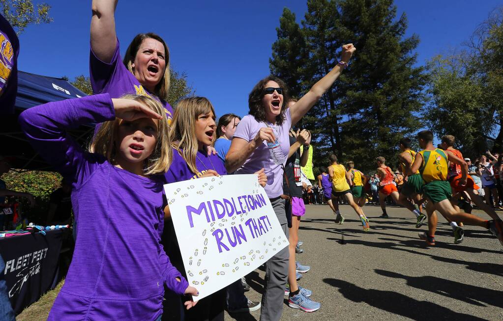 Middletown cross country supporters Maggie Rae Olson, Brooke Robles and Marcella Robles cheer on their team on the Spring Lake course in Santa Rosa on Saturday. (JOHN BURGESS / The Press Democrat)