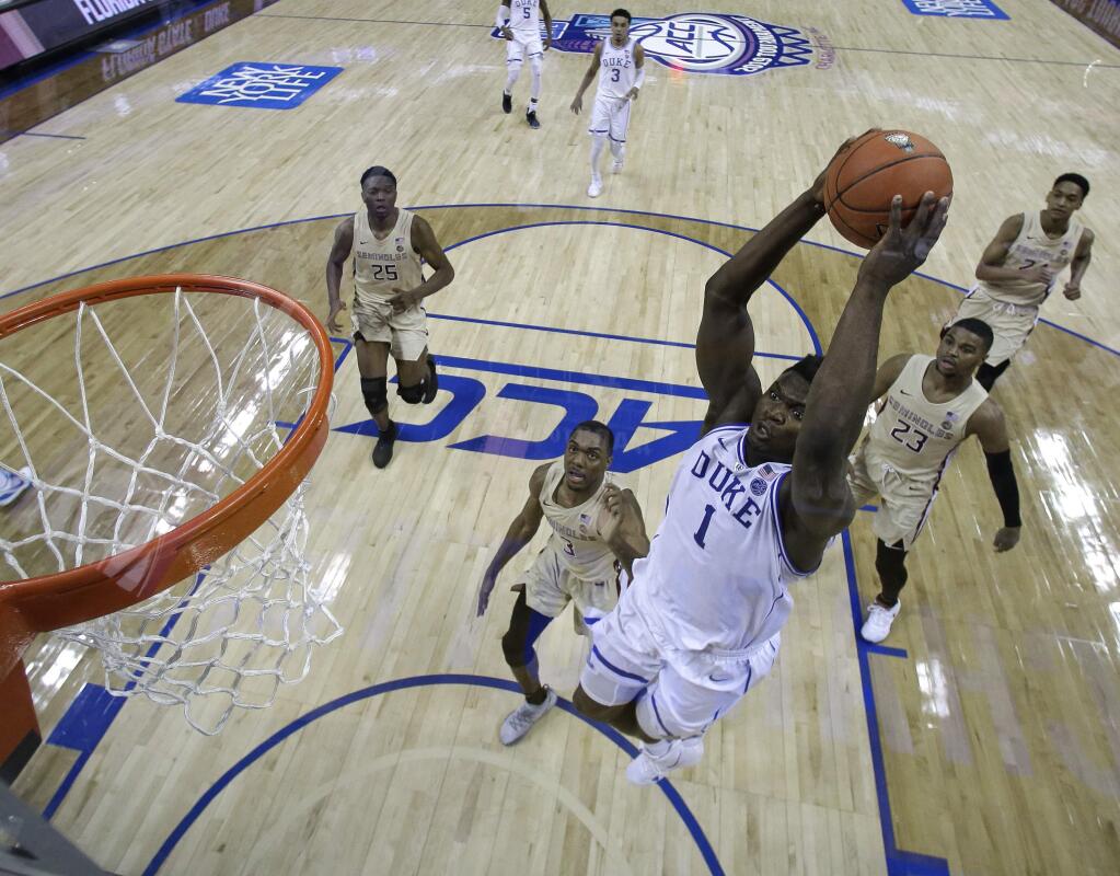 Duke's Zion Williamson goes up to dunk against Florida State during the first half of the championship game of the Atlantic Coast Conference tournament in Charlotte, N.C., Saturday, March 16, 2019. (AP Photo/Chuck Burton)