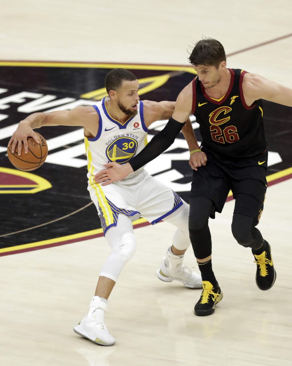 Golden State Warriors' Stephen Curry is defended by Cleveland Cavaliers' Kyle Korver during the first half of Game 4 of basketball's NBA Finals, Friday, June 8, 2018, in Cleveland. (AP Photo/Tony Dejak)