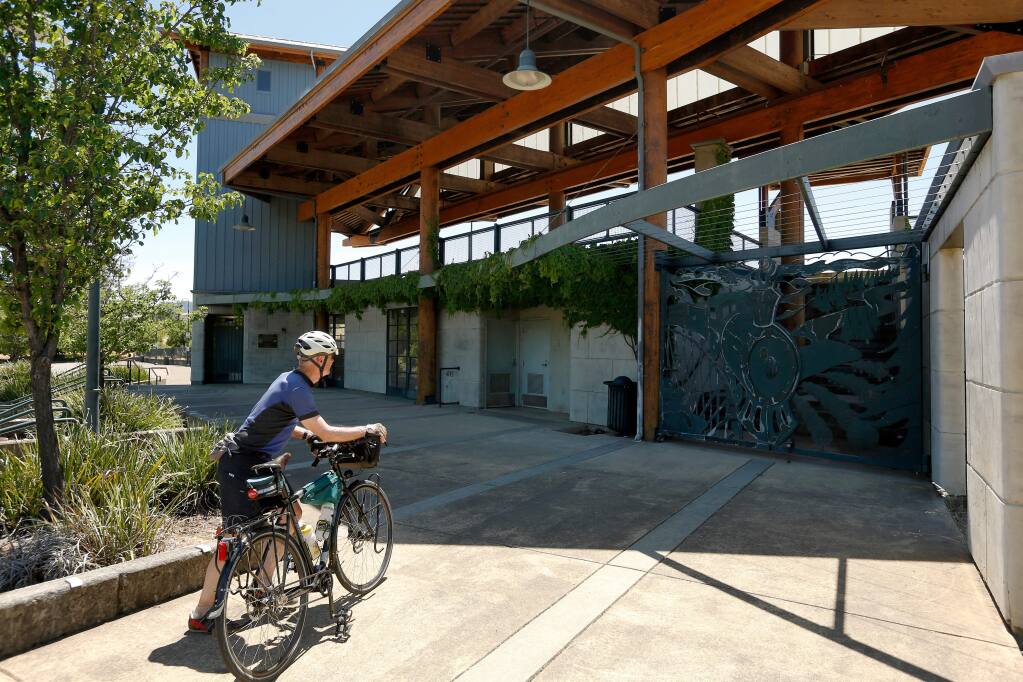 Dwayne Price of Larkspur dismounts his bicycle for a closer look at the Cloverdale Train Station in Cloverdale, California, on Friday, June 8, 2018. Price and his wife rode the SMART train from San Rafael to Santa Rosa for a northbound weekend bike excursion. (Alvin A.H. Jornada / The Press Democrat)