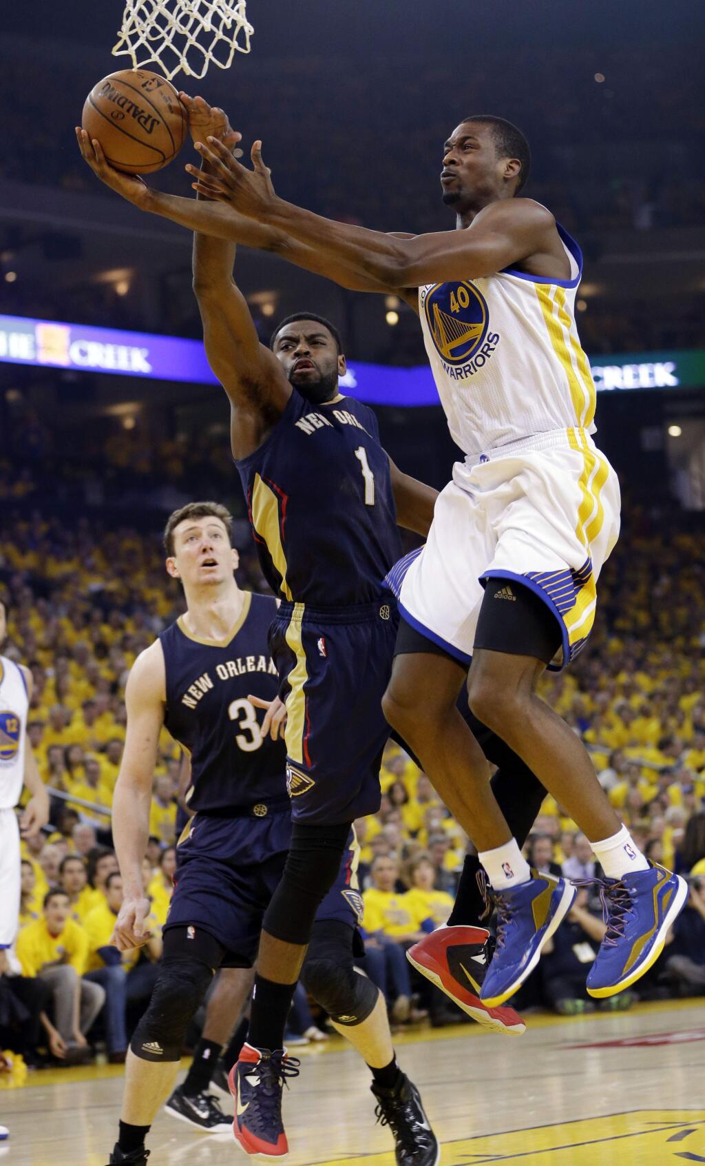 Golden State Warriors' Harrison Barnes (40) has his shot blocked by New Orleans Pelicans' Tyreke Evans (1) during the first half in Game 2 of a first-round NBA basketball playoff series Monday, April 20, 2015, in Oakland, Calif. (AP Photo/Marcio Jose Sanchez)