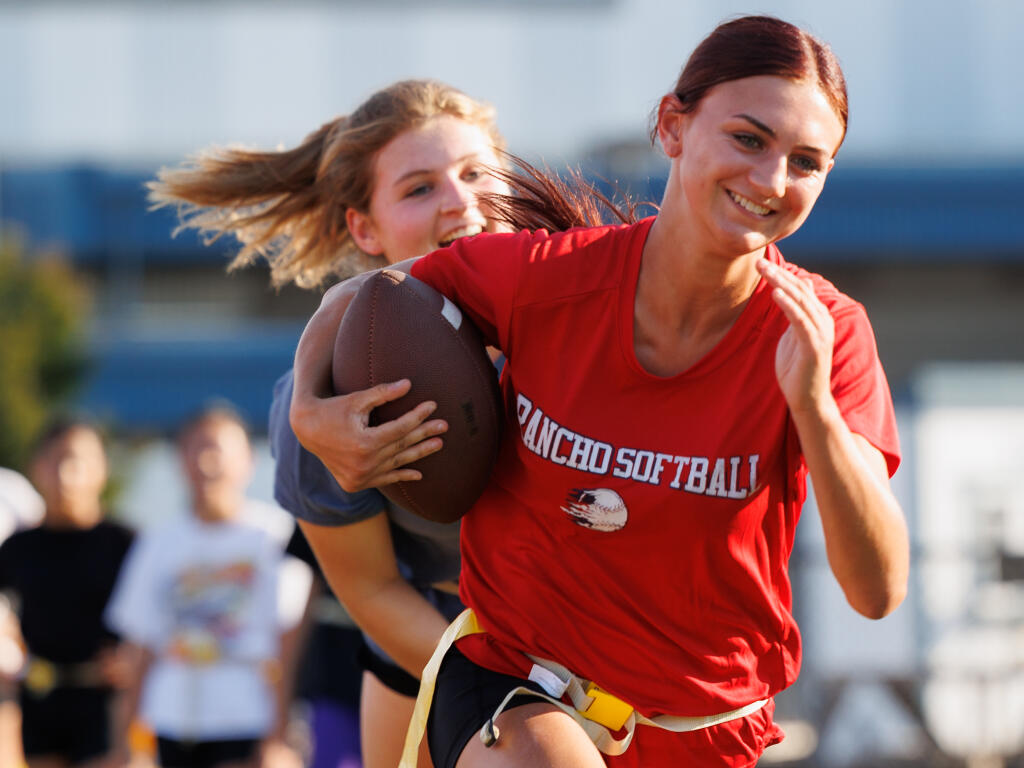 Cali Figoni outruns Jolee Gifford during Rancho Cotate’s girls flag football practicemin Rohnert Park, Friday, Aug.18, 2023. (Abraham Fuentes / For The Press Democrat file)