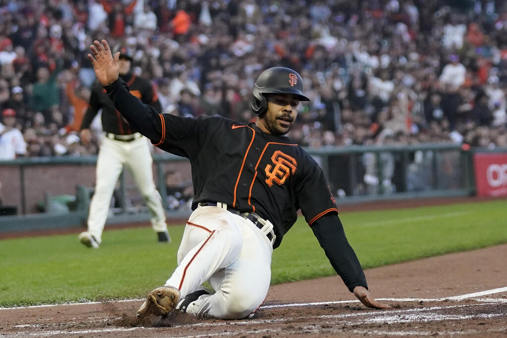 The Giants’ LaMonte Wade Jr. slides home to score against the Baltimore Orioles during the third inning in San Francisco, Saturday, June 3, 2023. (Jeff Chiu / ASSOCIATED PRESS)