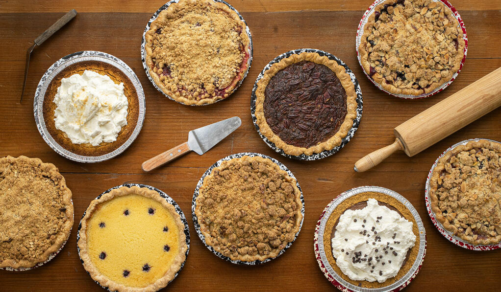A selection of pies from Chile Pies Baking Co. in Guerneville: top, left to right, Key Lime, Apple Raspberry, Mexican Chocolate Pecan, Pear Blueberry Cardamom; bottom left to right, Brown Butter Apple, Lemon Buttermilk, Green Chile Apple, Chocolate Cream and Pear Blueberry Cardamom. (John Burgess / The Press Democrat)