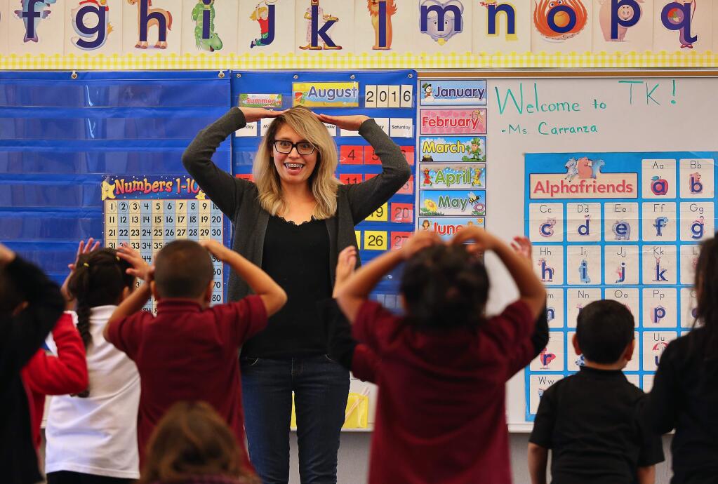 Transitional kindergarten teacher Areli Carranza leads her class in a song at Taylor Mountain Elementary School, in Santa Rosa, on Monday, August 22, 2016. (Christopher Chung/ The Press Democrat)