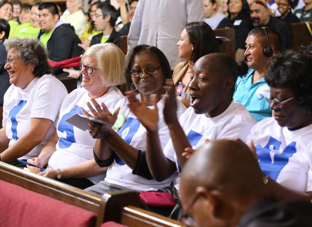 Supporters applaud during the minimum wage increase vote as the Los Angeles City Council votes to raise the minimum wage in the city to $15 an hour by 2020, making it the largest city in the nation to do so, in Los Angeles Tuesday, May 19, 2015. The measure approved Tuesday calls for small businesses with 25 or fewer employees to have an additional year to reach the $15 plateau. The council voted 14-1 after members of the public made impassioned statements for and against the plan. The increases begin with a wage of $10.50 in July 2016, followed by annual increases to $12, $13.25, $14.25 and then $15. Small businesses and nonprofits would be a year behind. (AP Photo/Damian Dovarganes )