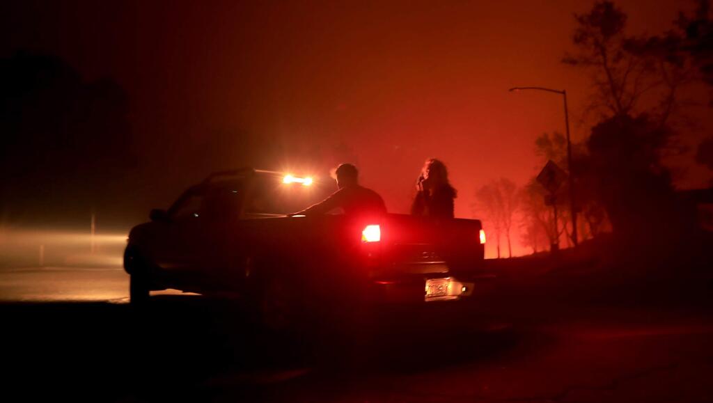 Guests of the Hilton Hotel in Fountaingrove, Monday Oct. 9, 2017 evacuate from the Tubbs fire in Santa Rosa. (Kent Porter / Press Democrat) 2017