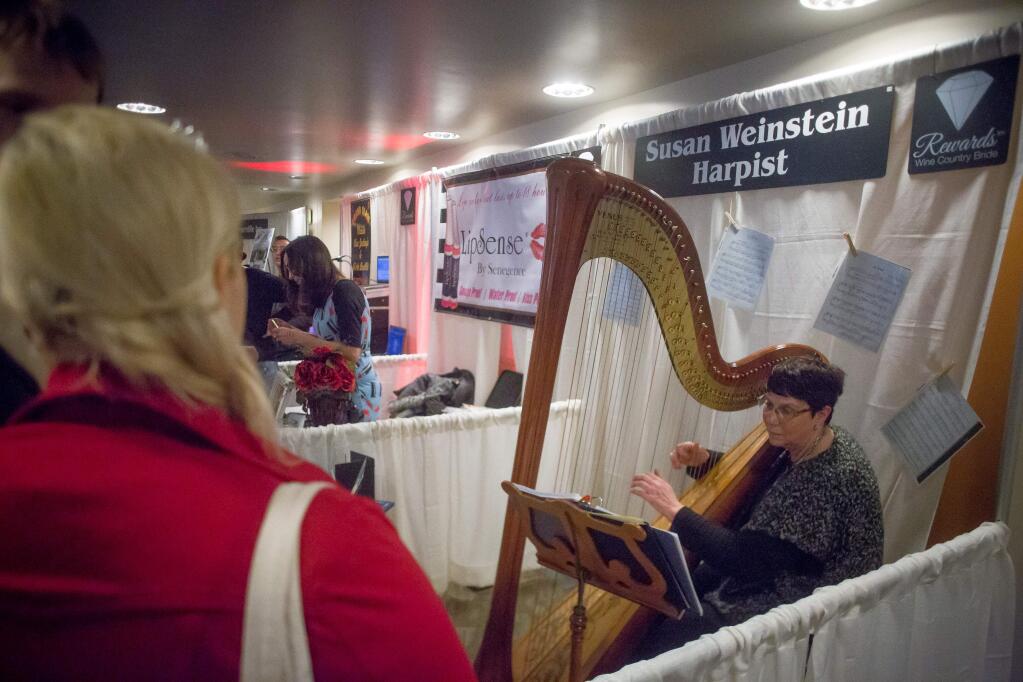 Susan Weinstein plays the harp for guests of the Sonoma County Wedding Expo at the Luther Burbank Center for the Arts in Santa Rosa, Calif. Saturday, January 21, 2017. (Jeremy Portje / For The Press Democrat)