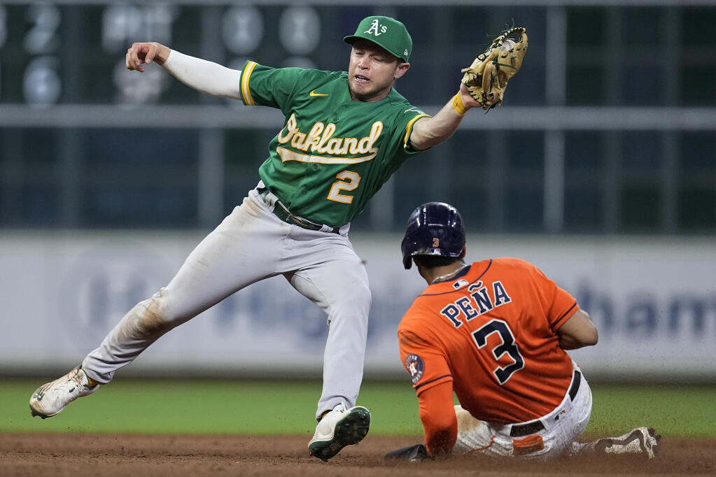 The Houston Astros' Jeremy Pena, right, steals second base under Oakland Athletics shortstop Nick Allen during the eighth inning Friday, Aug. 12, 2022, in Houston. (AP Photo/Kevin M. Cox)