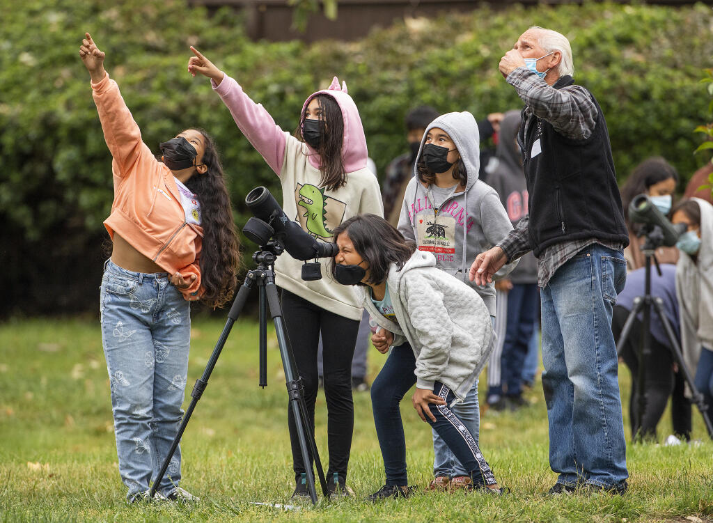From right, volunteer Ron Burrell points out a baby chick in a tree for excited Abraham Lincoln Elementary School 4th graders Camila Mendoza, Aylin Monroy, Kendra Cholua and Diana Lopez in Santa Rosa Friday, May 27, 2022.  (John Burgess / The Press Democrat)