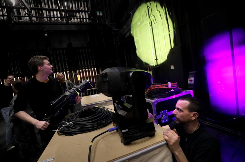 Lighting instructor Vince Mothersbaugh, right, trains theater students, including Kyle Sheridan, how to use a moving spotlight at the newly renovated Burbank Auditorium on the Santa Rosa Junior College campus in Santa Rosa on Friday, February 21, 2020. (BETH SCHLANKER/ The Press Democrat)