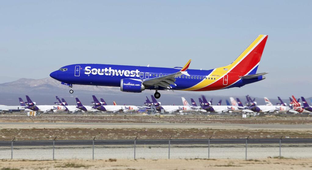 FILE - In this March 23, 2019, file photo, a Southwest Airlines Boeing 737 Max aircraft lands at the Southern California Logistics Airport in the high desert town of Victorville, Calif. A lawsuit filed against Southwest Airlines by a flight attendant alleges pilots on a 2017 flight had an iPad streaming video from a hidden camera in a bathroom in one of the airline's jets. Court filings by attorneys for Dallas-based Southwest and the two pilots denied the livestreaming allegations, and Southwest issued a brief statement Saturday, Oct. 26, saying it would not comment in detail on the suit but denied placing cameras in the lavatories in aircraft. (AP Photo/Matt Hartman, File)