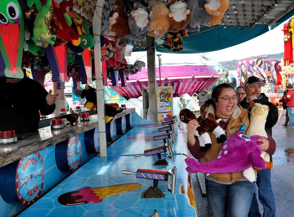 Holli Dooley, 23, who hasn't been to the fair since she was a little girl, cheers and jumps in excitement as she wins another stuffed animal prize to add to her winnings for the day, during the Citrus Fair in Cloverdale, California, on Saturday, February 16, 2019. (Alvin Jornada / The Press Democrat)