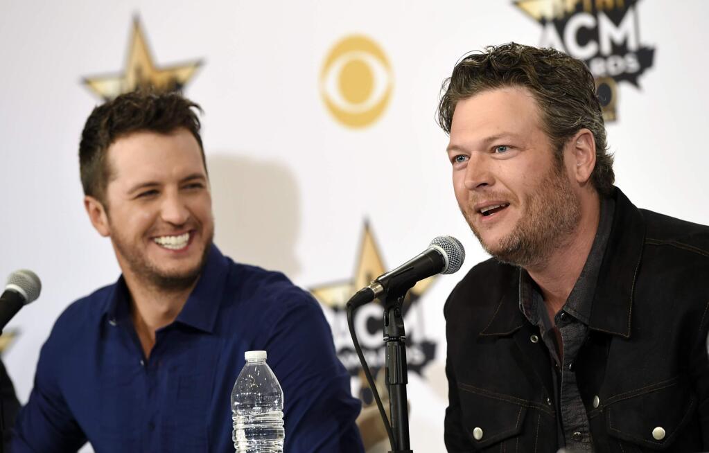 Blake Shelton, right, and Luke Bryan, co-hosts of Sunday's 50th Academy of Country Music Awards, laugh during a news conference on the event at AT&T Stadium on Friday, April 17, 2015, in Arlington, Texas. (Photo by Chris Pizzello/Invision/AP)