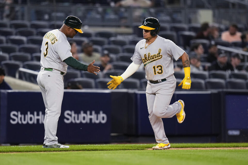 Oakland Athletics' Jordan Diaz (13) celebrates with third base coach Eric Martins after hitting a two-run home run against the New York Yankees during the eighth inning of a baseball game Tuesday, May 9, 2023, in New York. (AP Photo/Frank Franklin II)