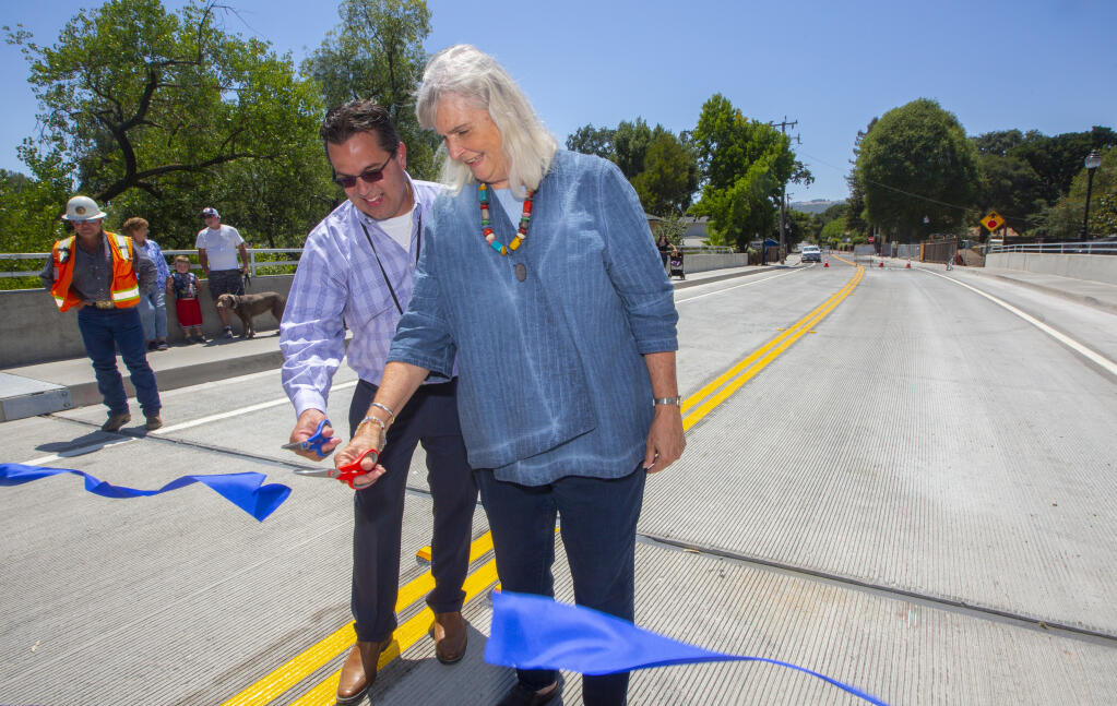Supervisor Susan Gorin and Johannes Hoevertsz of the Sonoma County Department of Transportation and Public Works, cut the ribbon at the ceremonial opening of the rebuilt Boyes Boulevard Bridge on Friday, July 16, 2021. The bridge will open to traffic sometime midweek.  (Photo by Robbi Pengelly/Index-Tribune)
