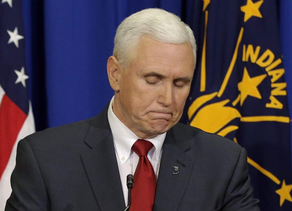 Indiana Gov. Mike Pence listens to a question during a news conference, Tuesday, March 31, 2015, in Indianapolis. Pence said that he wants legislation on his desk by the end of the week to clarify that a new religious-freedom law does not allow discrimination. The law has triggered an outcry, with businesses and organizations voicing concern and some states barring government-funded travel to the Midwestern state. (AP Photo/Darron Cummings)
