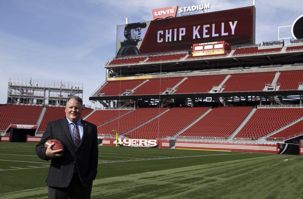 San Francisco 49ers new head coach Chip Kelly holds a football on the field at Levi Stadium Wednesday, Jan. 20, 2016, in Santa Clara, Calif. (AP Photo/Ben Margot)