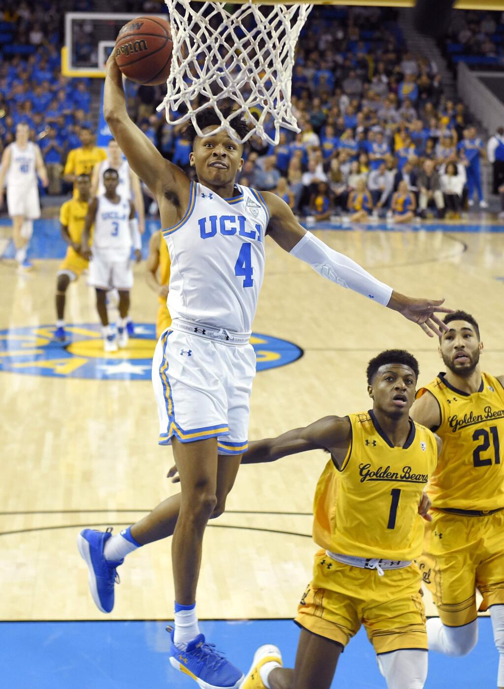 UCLA guard Jaylen Hands goes up for a dunk as Cal guards Darius McNeill, center, and Nick Hamilton defend during the second half Thursday, Jan. 25, 2018, in Los Angeles. UCLA won 70-57. (AP Photo/Mark J. Terrill)