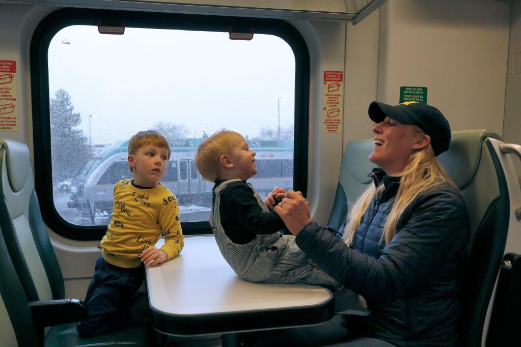Erinn Maloney of Calistoga plays with her sons Marcus, 1, and Nathan, 4, before the SMART train departs the Santa Rosa airport train station, in Santa Rosa, California, on Saturday, Nov. 30, 2019. (ALVIN JORNADA/ PD)