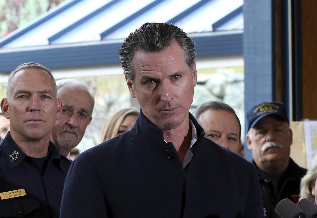 Gov. Gavin Newsom listens to a reporter's question during his visit to the California Department of Forestry and Fire Protection CalFire Colfax Station Tuesday, Jan. 8, 2019, in Colfax, Calif. On his first full day as governor, Newsom announced executive actions to improve the state's response to wildfires and other emergencies. (AP Photo/Rich Pedroncelli)