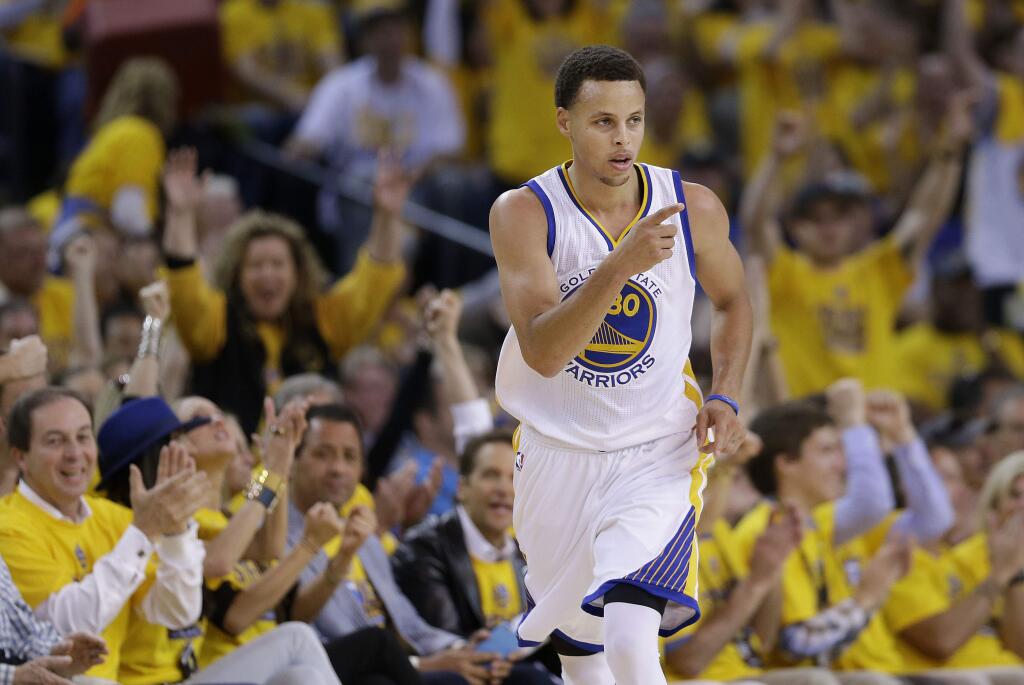 Golden State Warriors guard Stephen Curry (30) reacts after scoring against the Memphis Grizzlies during the first half of Game 1 in a second-round NBA playoff basketball series in Oakland, Calif., Sunday, May 3, 2015. (AP Photo/Marcio Jose Sanchez)