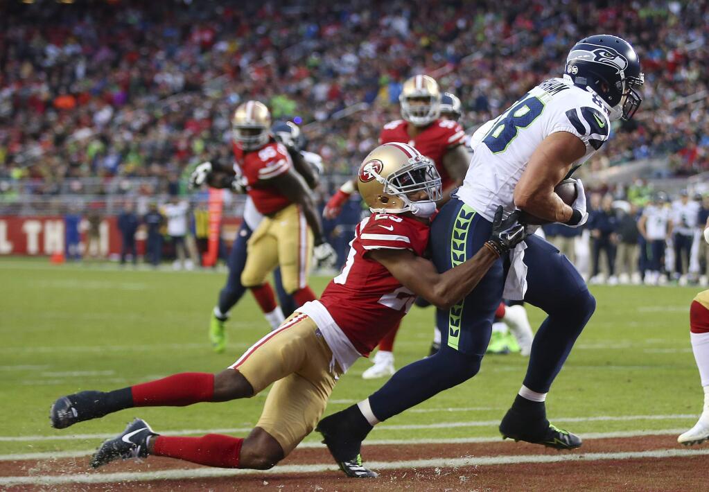 Seattle Seahawks tight end Jimmy Graham, right, makes a touchdown catch past San Francisco 49ers cornerback Ahkello Witherspoon during the second half of an NFL football game Sunday, Nov. 26, 2017, in Santa Clara, Calif. (AP Photo/John Hefti)