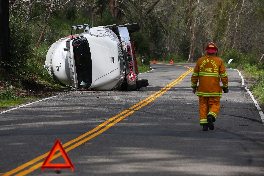 An overturned propane truck closed Highway 128 northwest of Calistoga, between Woodleaf and Kellogg, on Tuesday, March 19, 2019. (Christopher Chung/ The Press Democrat)