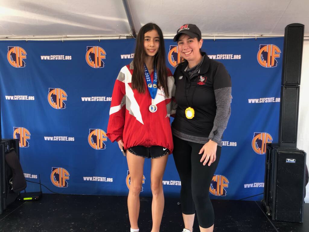 Montgomery High School freshman Hanne Thomsen, left, with coach Melody Karpinski, after winning the CIF State Division 3 cross country meet on Nov. 27, 2021 in Fresno.