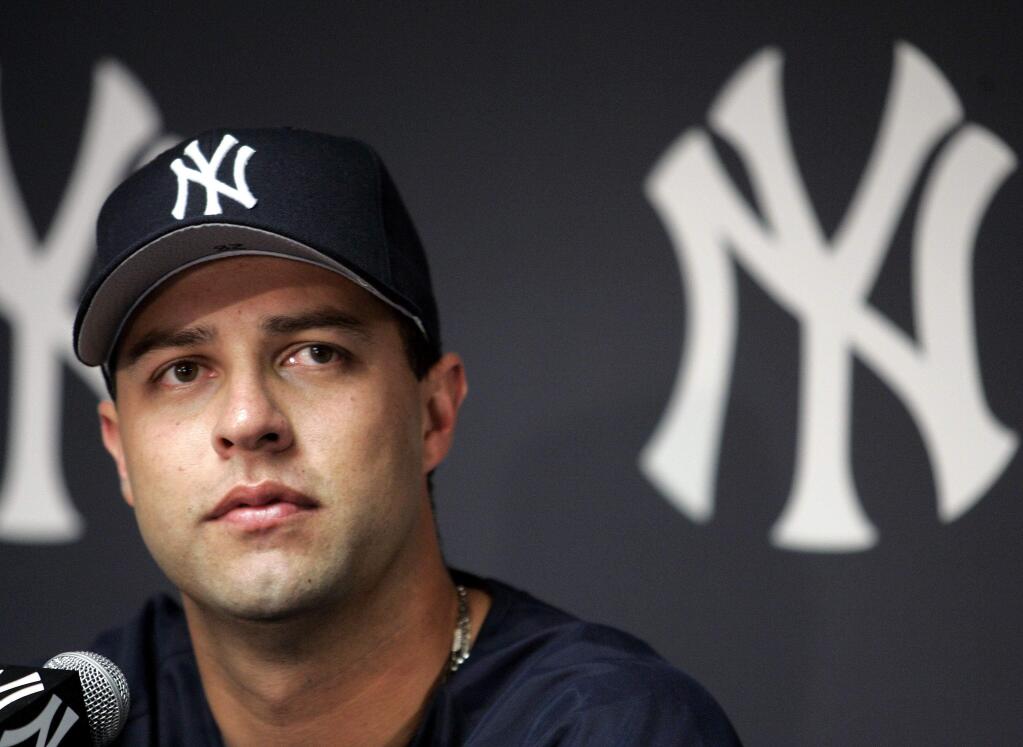 FILE - In this Aug. 1, 2004, file photo, New York Yankees pitcher Esteban Loaiza talks to reporters during a news conference at Yankee Stadium in New York. Former Major League Baseball pitcher Esteban Loaiza has been arrested in California on suspicion of smuggling cocaine and heroin. The San Diego County Sheriff's Department says Loaiza was booked into jail Friday, Feb. 9, 2018, evening and held in lieu of $200,000 bail.(AP Photo/Ed Betz)
