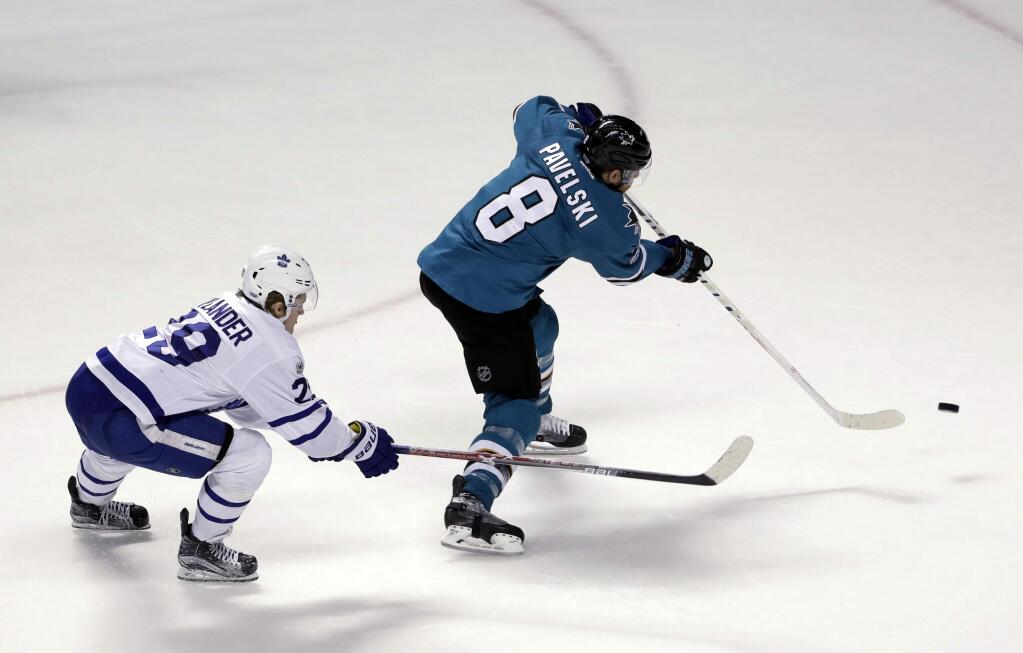 San Jose Sharks' Joe Pavelski (8) scores an empty-net goal past Toronto Maple Leafs' William Nylander, left, during the third period Tuesday, Feb. 28, 2017, in San Jose. San Jose won 3-1. (AP Photo/Marcio Jose Sanchez)