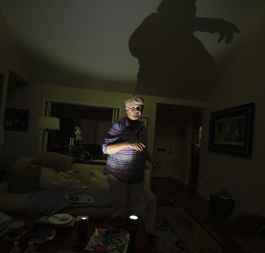 Lone Foss is fearful of candles after losing her Fountaingrove home in the October 2017 wildfires, so she lights her Oakmont home with LED flashlights. (photo by John Burgess/The Press Democrat)