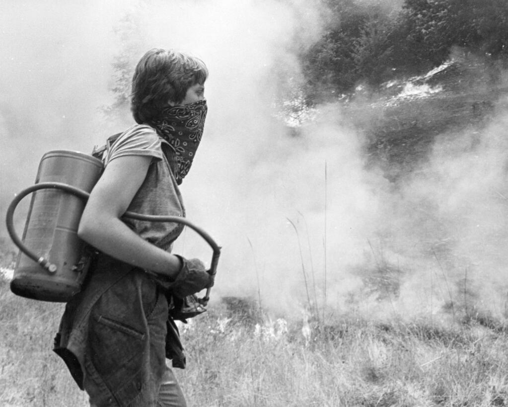 A woman covers her face with a bandana while helping to combat the Creighton Ridgefire in 1978. (Joe Price Jr. / The Press Democrat)