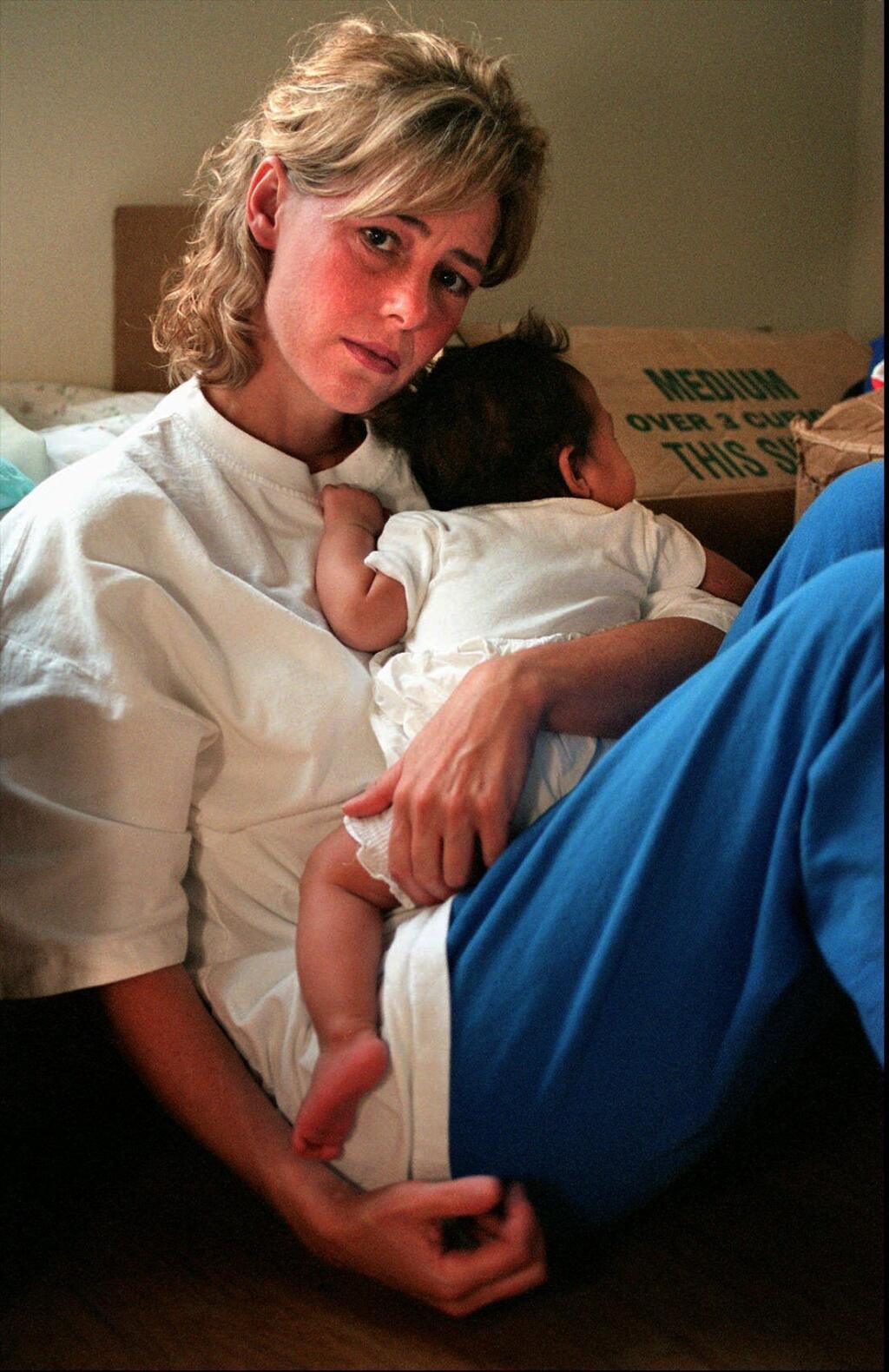 FILE - In this July 20, 1997, file photo, Mary Kay Letourneau holds the baby, in Normandy Park, Wash., that was fathered by a boy she once taught as an elementary school teacher. Letourneau, who married her former sixth-grade student after she was convicted for raping him, has died. She was 58. Her lawyer David Gehrke told news outlets Letourneau died Tuesday, July 7, 2020, of cancer. The former suburban Seattle teacher was arrested in 1997 after she became pregnant with Vili Fualaau's child. She later pleaded guilty to second-degree child rape. (Betty Udesen/The Seattle Times via AP, File)