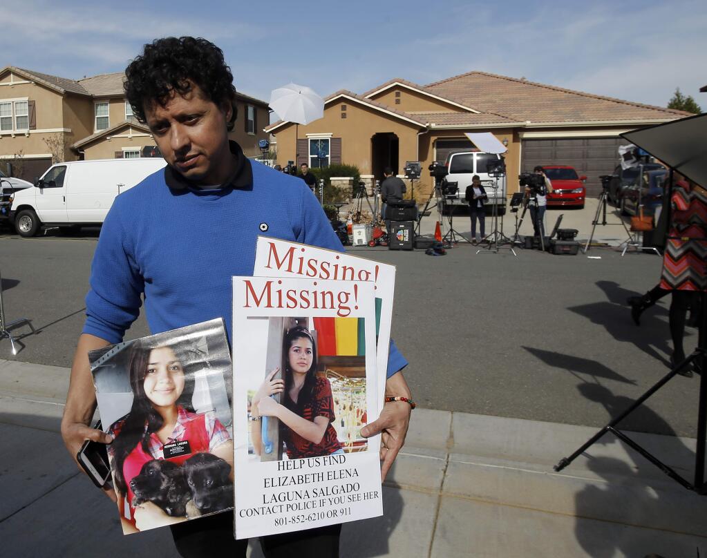 Rudemberth Salgado is looking for his cousin Elizabeth Salgado, and thought that she may be one of the people held by parents that were arrested in his neighborhood Sunday after several children were found chained in the house on the 100 block of Muir Woods Rd. in Perris, Calif., Tuesday, Jan. 16, 2018. Authorities said an emaciated teenager led deputies to the California home where her 12 brothers and sisters were locked up in filthy conditions, with some of them malnourished and chained to beds. Ellizabeth Salgado has been missing for two years, last seen in Provo, Utah. (AP Photo/Alex Gallardo)