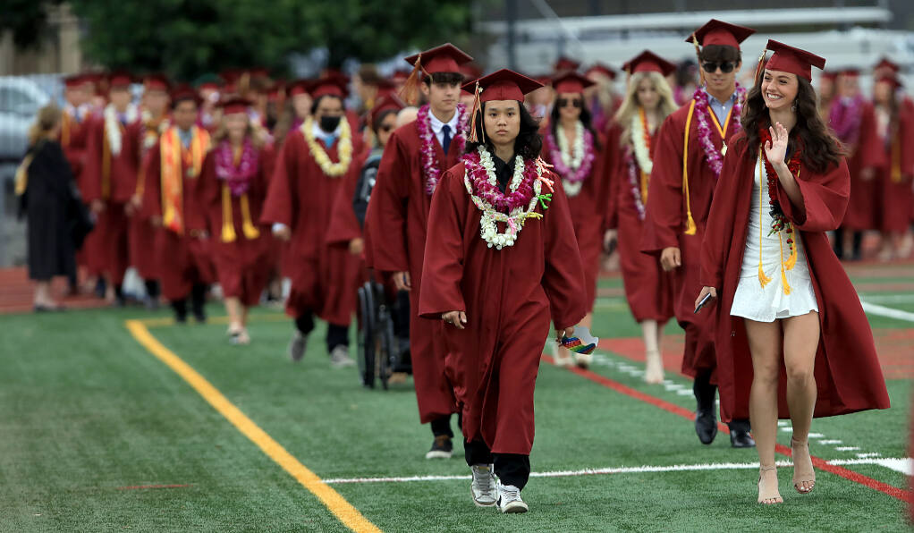 Cardinal Newman High School seniors walk on to the school football field for their commencement ceremony, Saturday, June 4, 2022 in Santa Rosa. (Kent Porter / The Press Democrat) 2022