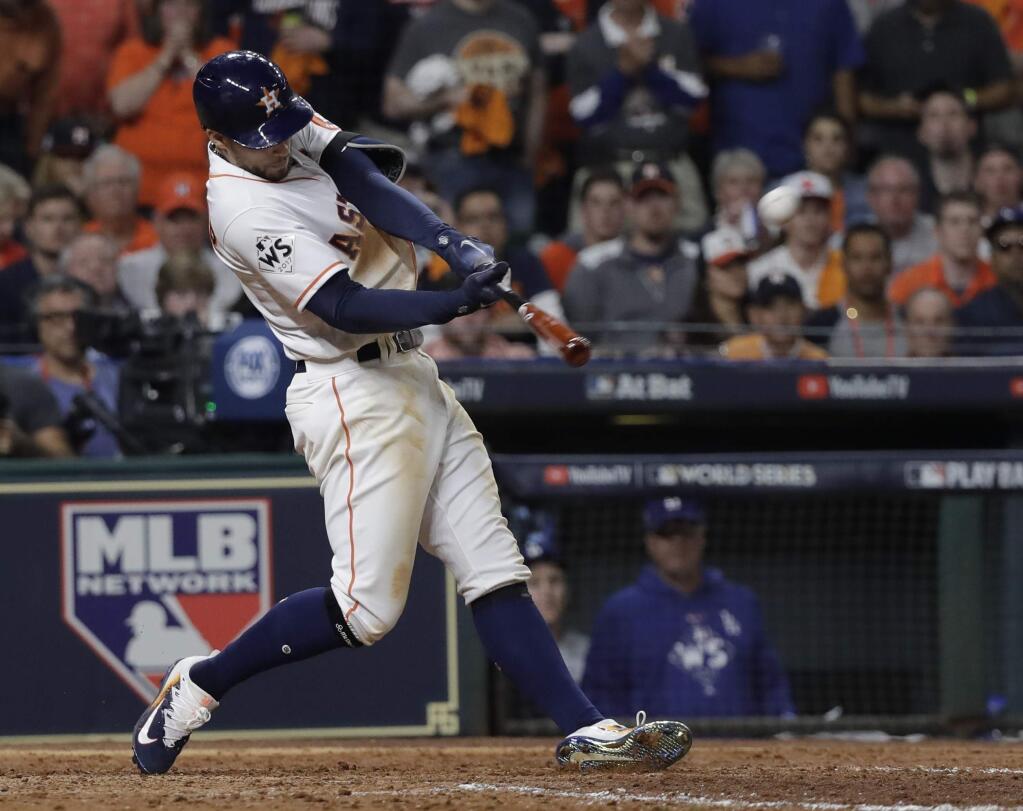 Houston Astros' George Springer hits a home run during the seventh inning of Game 5 of baseball's World Series against the Los Angeles Dodgers Sunday, Oct. 29, 2017, in Houston. (AP Photo/David J. Phillip)