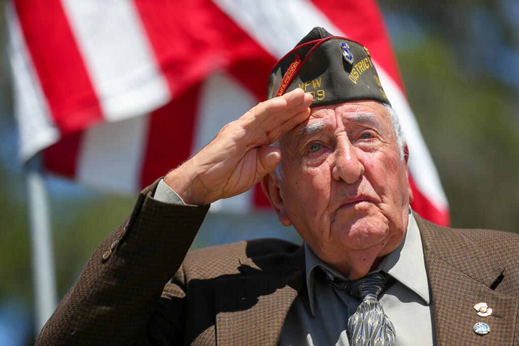 U.S. Air Force veteran Lionel Parriera salutes for the singing of the Star Spangled Banner during the Memorial Day ceremony at Cypress Hill Memorial Park in Petaluma, Monday, May 30, 2022.  (Christopher Chung / The Press Democrat file)