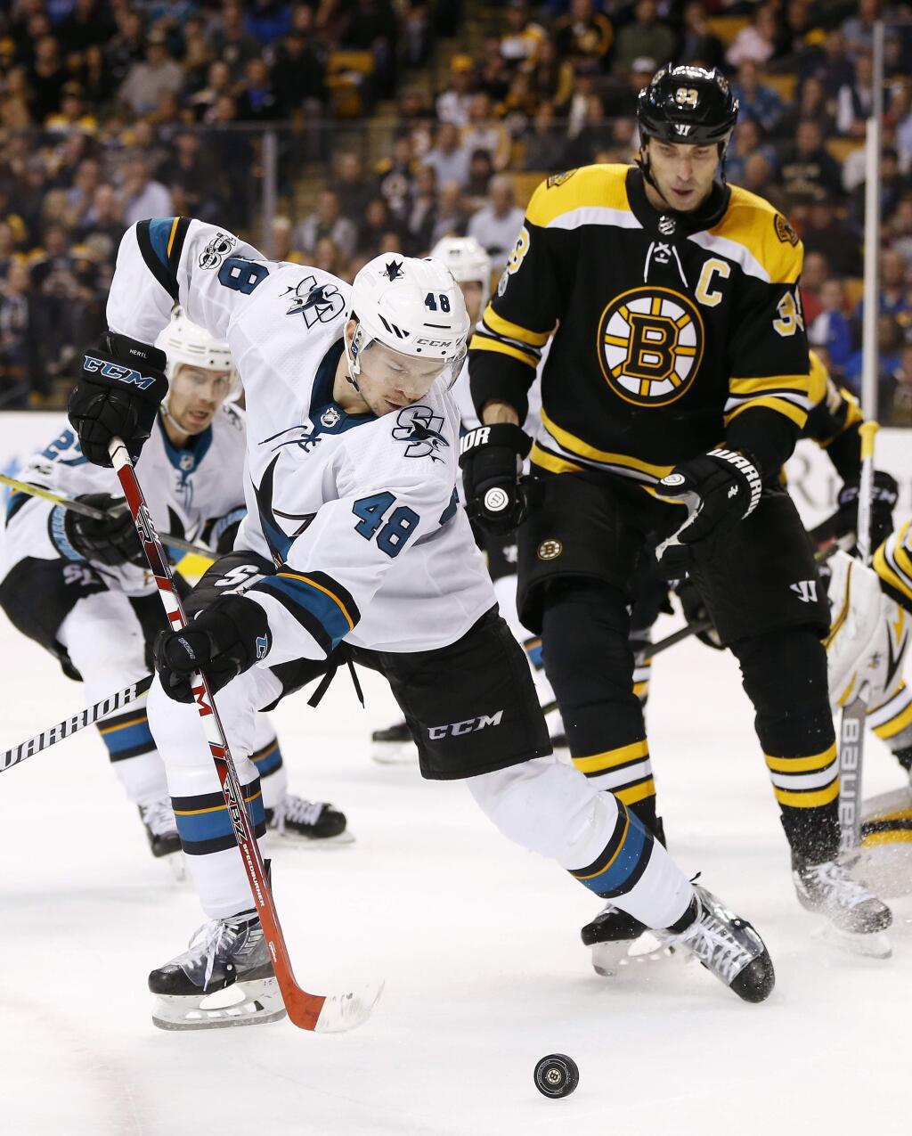 The San Jose Sharks' Tomas Hertl (48) tries to control the puck in front of Boston Bruins' Zdeno Chara (33) during the third period in Boston, Thursday, Oct. 26, 2017. The Bruins won 2-1. (AP Photo/Michael Dwyer)