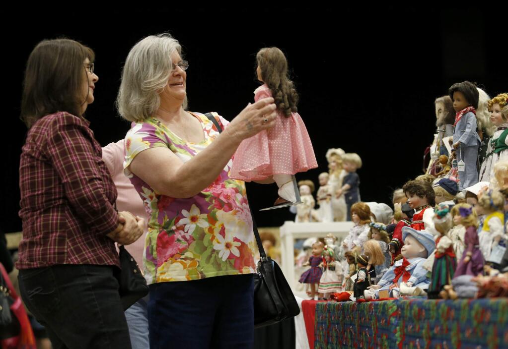 Patti Schacht and Nancy Fullmer, left, check out a Deanna Durbin doll during the Doll and Toy Show at the Santa Rosa Veterans Memorial Auditorium on Sunday, November 6, 2016 in Santa Rosa, California . (BETH SCHLANKER/ The Press Democrat)