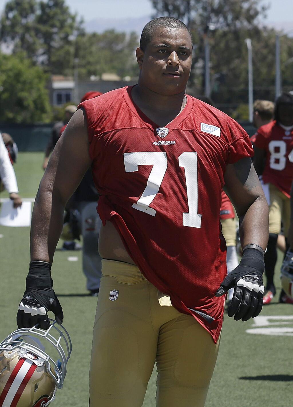 In this June 19, 2014, file photo, San Francisco 49ers offensive tackle Jonathan Martin walks off the field during NFL football minicamp in Santa Clara. Martin is concerning himself with all that he can control to earn a spot on the 53-man roster when final cuts are complete Aug. 30. (AP Photo/Jeff Chiu, File)